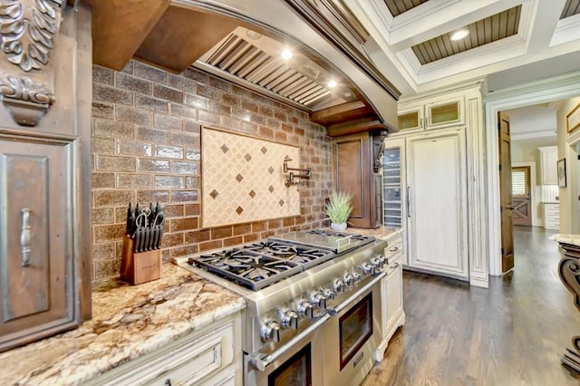 kitchen featuring crown molding, tasteful backsplash, light stone countertops, and range with two ovens