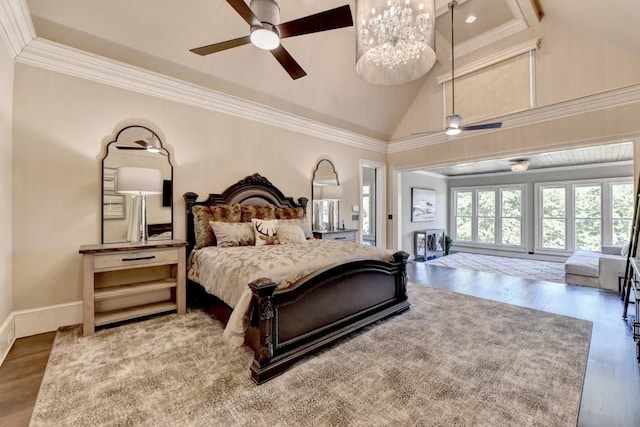 bedroom with crown molding, wood finished floors, baseboards, lofted ceiling, and an inviting chandelier
