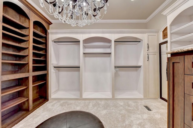 walk in closet with a notable chandelier