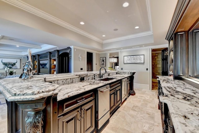 kitchen with a sink, a raised ceiling, crown molding, and stainless steel dishwasher