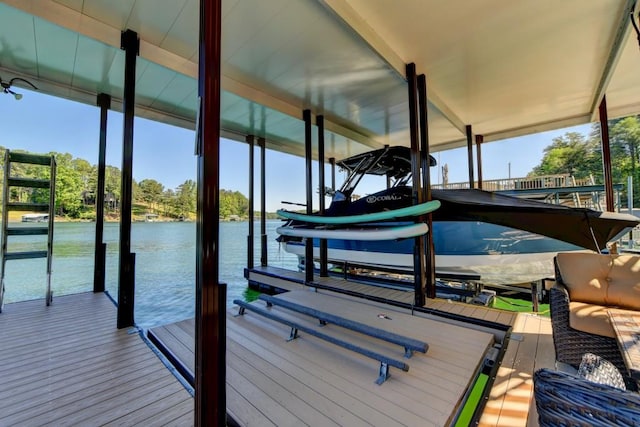 dock area with boat lift and a water view