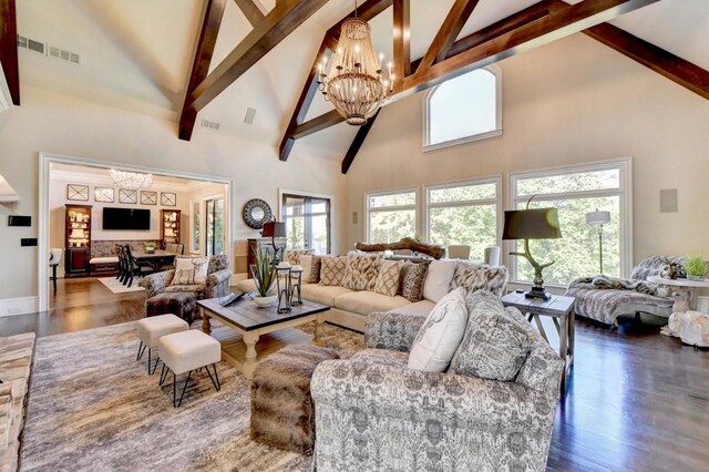 living room featuring an inviting chandelier, beam ceiling, high vaulted ceiling, and wood finished floors