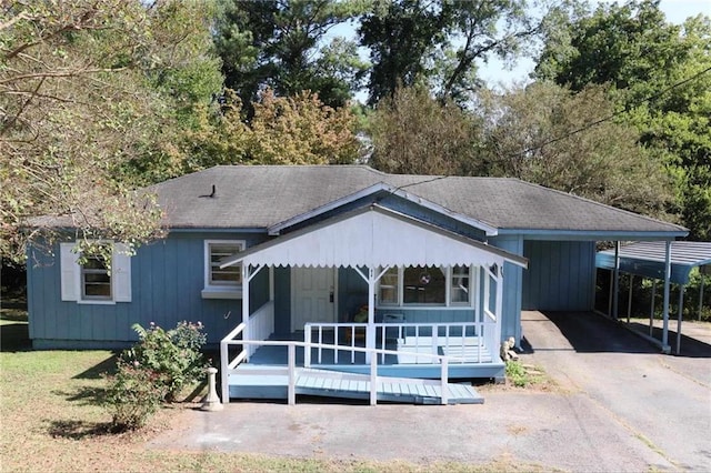 view of front of property with covered porch and a shingled roof