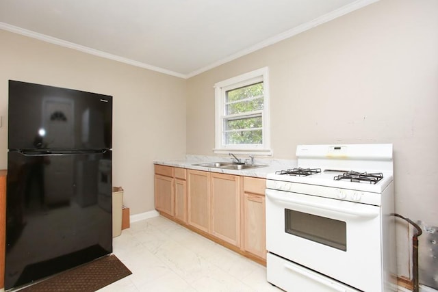 kitchen featuring crown molding, light countertops, white range with gas cooktop, freestanding refrigerator, and a sink