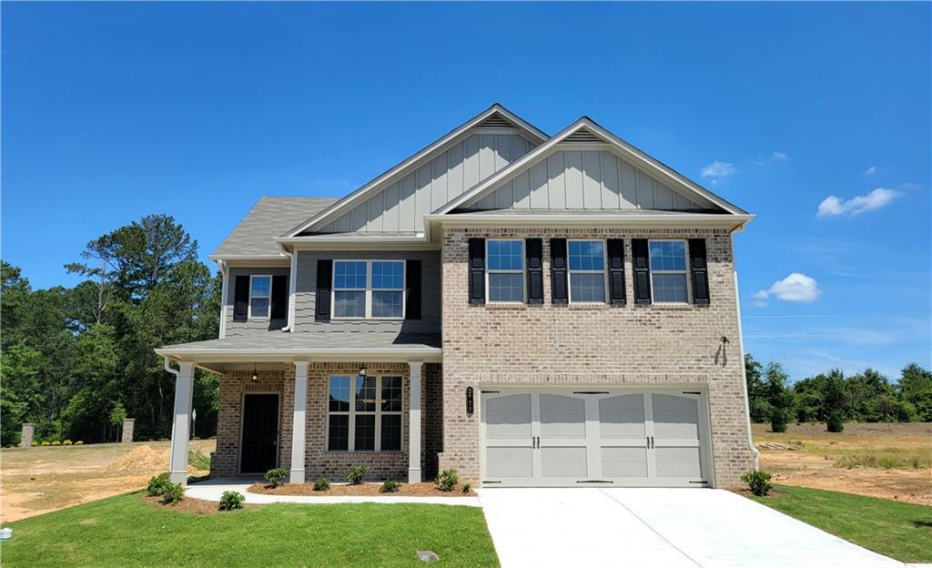 craftsman-style home with a porch, a garage, and a front lawn