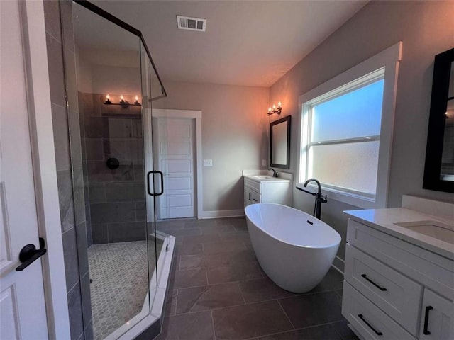 full bath with a stall shower, a soaking tub, a sink, and visible vents