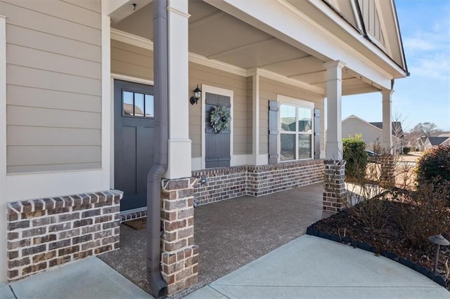 view of exterior entry with a porch