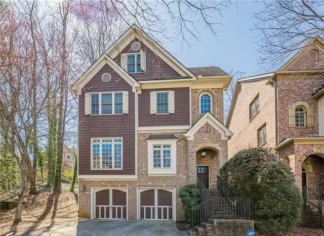 view of front of house with a garage, brick siding, and driveway