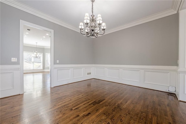 unfurnished room featuring an inviting chandelier, dark wood-style flooring, and crown molding