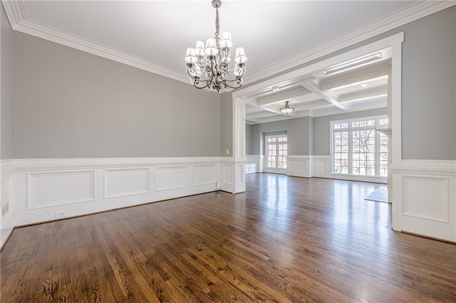 unfurnished room with dark wood finished floors, beam ceiling, coffered ceiling, and an inviting chandelier