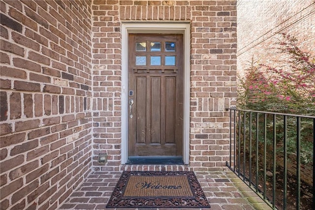 doorway to property with brick siding