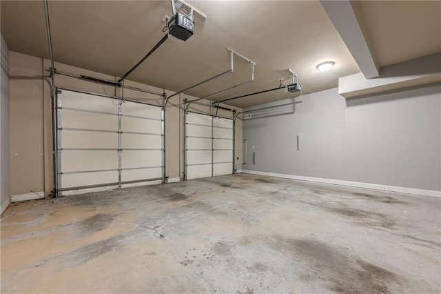 garage with a garage door opener and baseboards