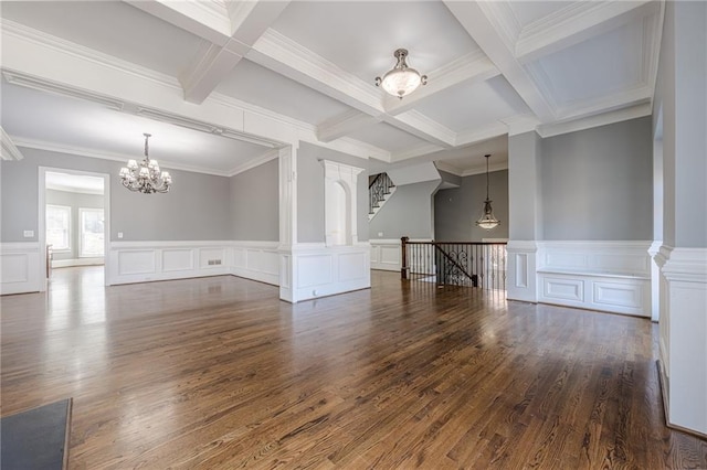 unfurnished room featuring dark wood finished floors, beamed ceiling, and a notable chandelier