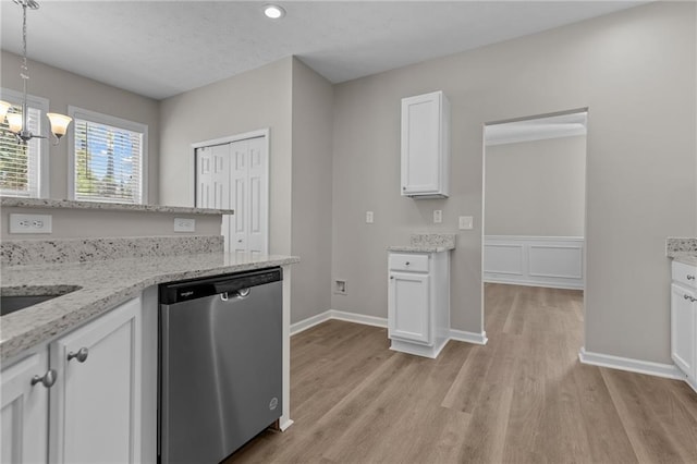 kitchen with a notable chandelier, white cabinetry, stainless steel dishwasher, light wood-type flooring, and light stone countertops