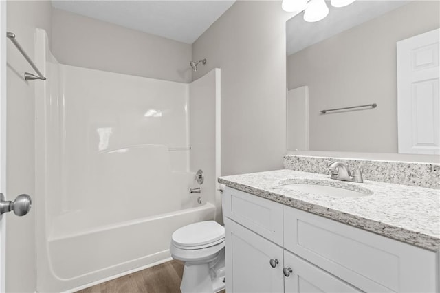 full bath with shower / washtub combination, vanity, toilet, and wood finished floors