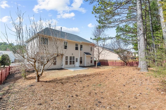 rear view of property with a patio area and a fenced backyard