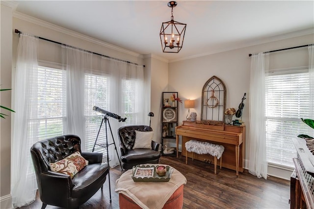 sitting room featuring ornamental molding, plenty of natural light, dark hardwood / wood-style floors, and an inviting chandelier