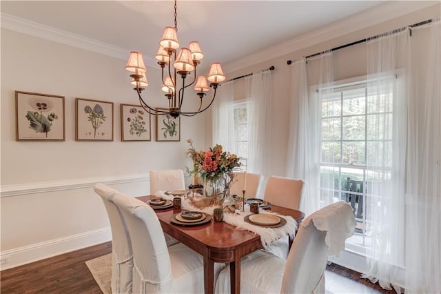 dining space with dark hardwood / wood-style flooring, a notable chandelier, and ornamental molding