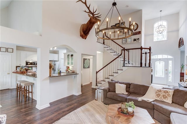 living room with a high ceiling and dark hardwood / wood-style floors