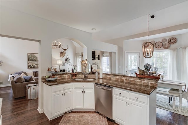 kitchen with white cabinetry, sink, dark stone countertops, and dishwasher