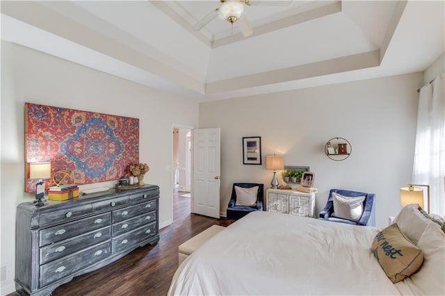 bedroom featuring ceiling fan, dark hardwood / wood-style flooring, a raised ceiling, and a towering ceiling