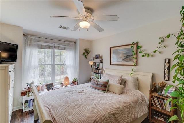 bedroom with dark wood-type flooring and ceiling fan