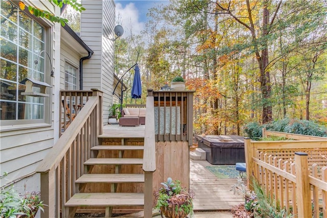 wooden deck with a hot tub