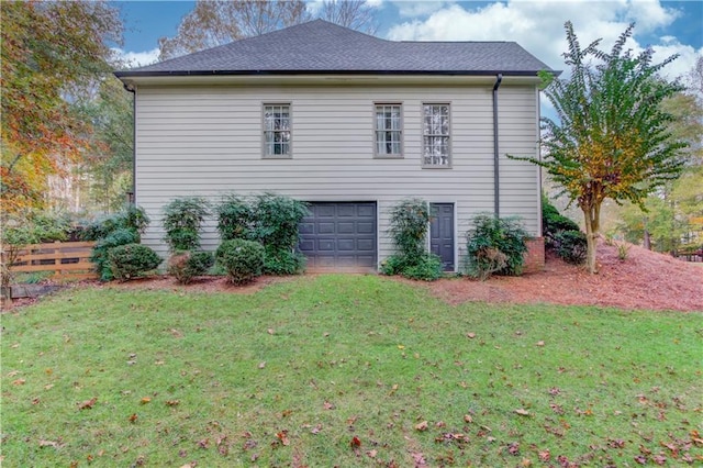 view of home's exterior with a garage and a yard