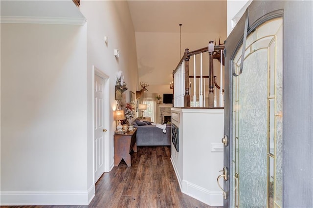 corridor with hardwood / wood-style floors and ornamental molding