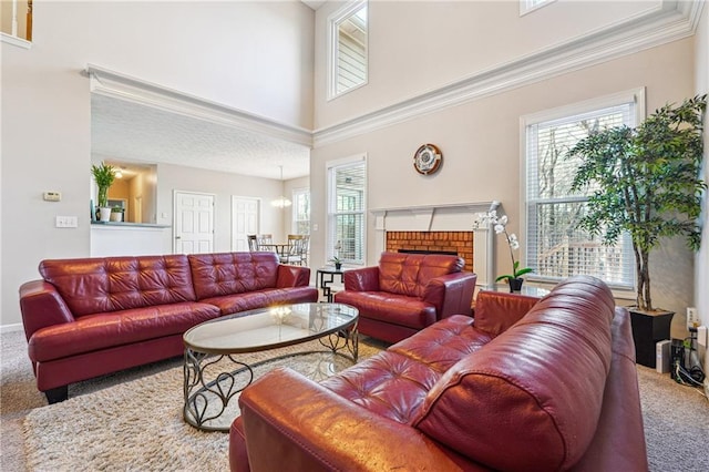 living room with carpet flooring, a towering ceiling, and a fireplace