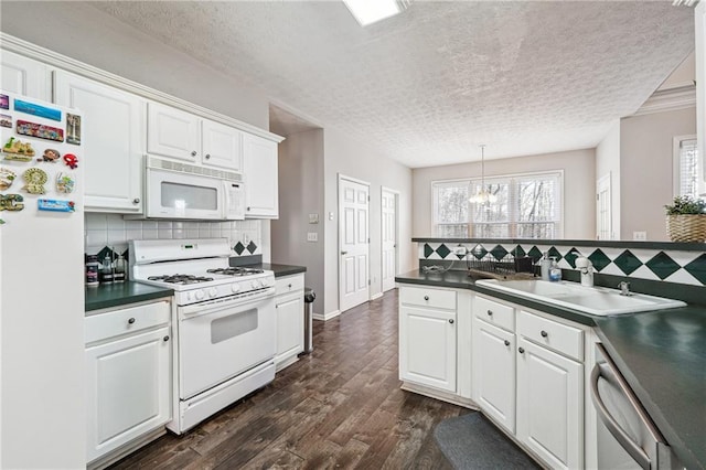 kitchen with a textured ceiling, sink, white cabinets, and white appliances