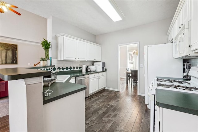 kitchen featuring white appliances, backsplash, white cabinets, ceiling fan, and kitchen peninsula