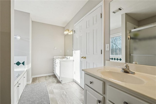 bathroom with vanity and shower with separate bathtub