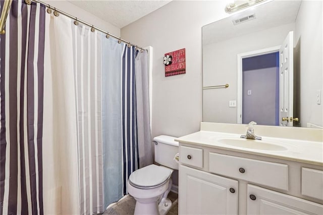 bathroom featuring vanity, toilet, and curtained shower