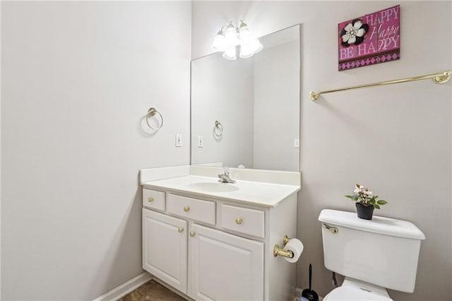 bathroom featuring vanity, a notable chandelier, and toilet