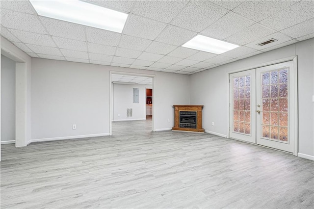 unfurnished living room featuring french doors and light hardwood / wood-style flooring