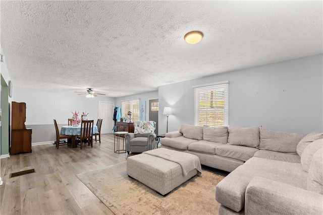 165 Grant Ford Dr, Dawsonville, GA 30534 - living room with ceiling fan, a textured ceiling, and light wood-style flooring