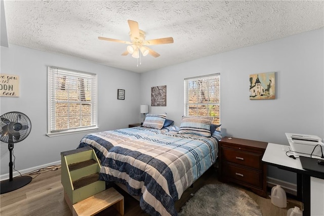 165 Grant Ford Dr, Dawsonville, GA 30534 - bedroom featuring a textured ceiling, wood finished floors, ceiling fan, and baseboards