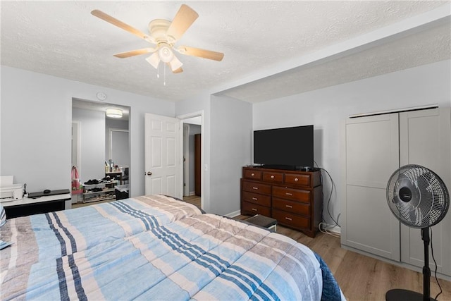 165 Grant Ford Dr, Dawsonville, GA 30534 - bedroom featuring wood finished floors, a textured ceiling, and ceiling fan