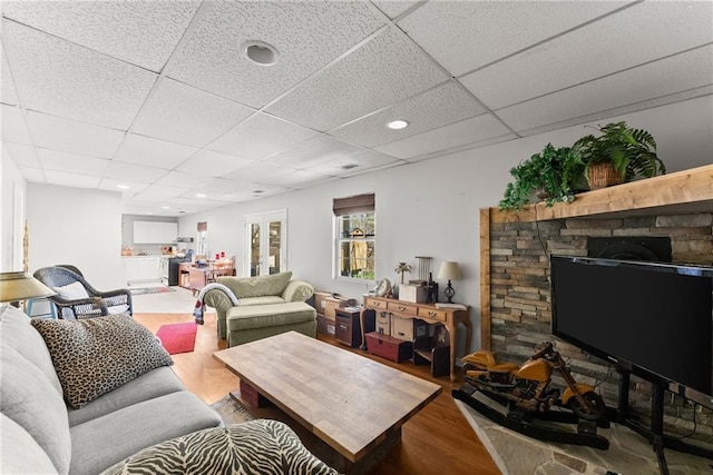 165 Grant Ford Dr, Dawsonville, GA 30534 - living area featuring wood finished floors, a drop ceiling, and a stone fireplace