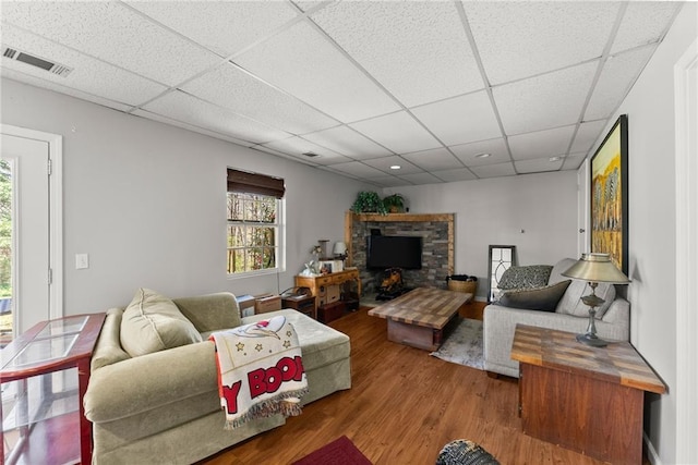165 Grant Ford Dr, Dawsonville, GA 30534 - living room featuring wood finished floors, a drop ceiling, and a fireplace with raised hearth