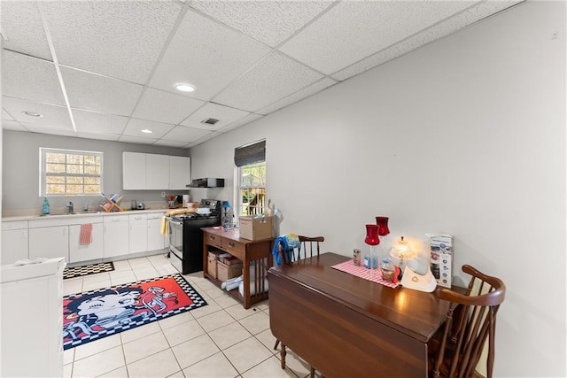165 Grant Ford Dr, Dawsonville, GA 30534 - kitchen featuring black range with electric cooktop, a paneled ceiling, white cabinetry, light countertops, and light tile patterned flooring