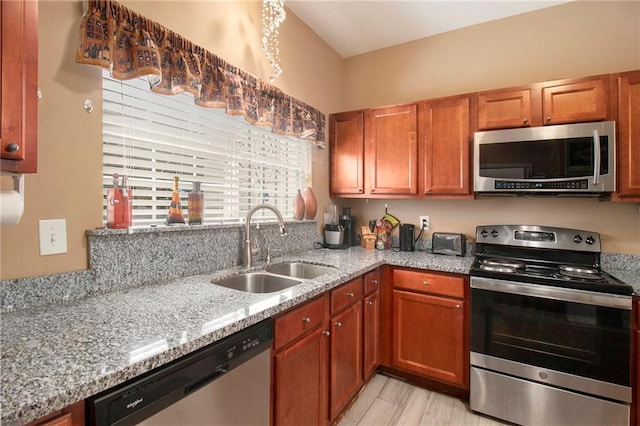 7324 Bridlewood Ct, Jonesboro, GA 30236 - kitchen with appliances with stainless steel finishes, light stone counters, and brown cabinetry