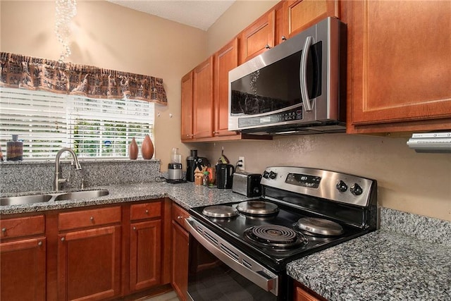 7324 Bridlewood Ct, Jonesboro, GA 30236 - kitchen with appliances with stainless steel finishes, brown cabinets, and dark stone counters