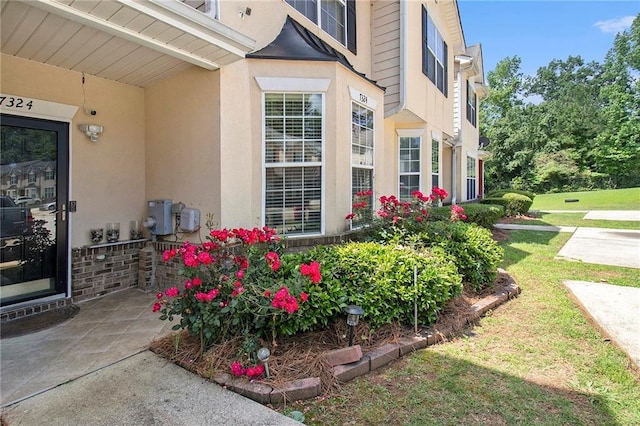 7324 Bridlewood Ct, Jonesboro, GA 30236 - entrance to property with stucco siding and a lawn