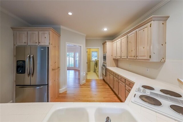 kitchen with ornamental molding, light brown cabinets, recessed lighting, light wood-style flooring, and stainless steel appliances