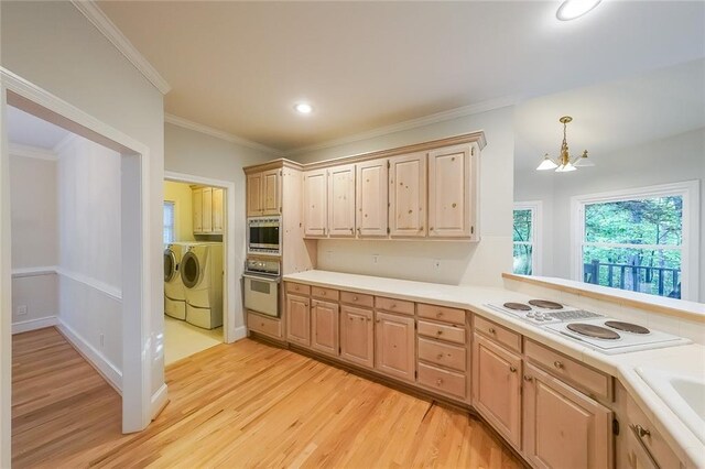 kitchen with a notable chandelier, washing machine and dryer, light brown cabinets, and white appliances
