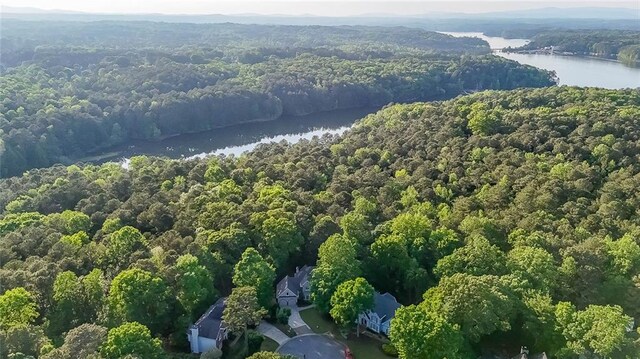 aerial view featuring a view of trees and a water view