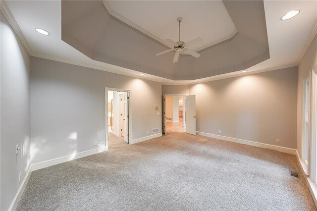 unfurnished room with light carpet, baseboards, recessed lighting, a tray ceiling, and a ceiling fan