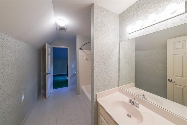 full bathroom with vanity, tile patterned floors, shower / bathing tub combination, lofted ceiling, and visible vents
